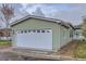 Attached two-car garage featuring a white door and manicured landscaping, enhancing curb appeal at 7971 Larkspur Cir # 219, Frederick, CO 80530