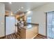 Efficient kitchen design with wood floors, countertops, and a full suite of appliances at 7971 Larkspur Cir # 219, Frederick, CO 80530