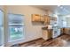 Well-lit kitchen featuring wood cabinets, white appliances, and a window overlooking the backyard at 7971 Larkspur Cir # 219, Frederick, CO 80530