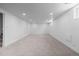 Spacious basement with carpeted floor, recessed lighting, and stairs to upper level at 3055 S Winona Ct, Denver, CO 80236