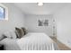 Bedroom with a comfy bed, natural light from two windows, and simple decor at 3055 S Winona Ct, Denver, CO 80236