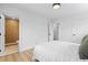 Bedroom with simple decor, and doorway to bathroom featuring modern fixtures at 3055 S Winona Ct, Denver, CO 80236