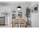 Inviting dining area with modern lighting, a stylish table setting, and access to the backyard at 3055 S Winona Ct, Denver, CO 80236