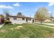 Charming ranch-style house with a well-maintained lawn, mature trees, and inviting curb appeal at 3055 S Winona Ct, Denver, CO 80236