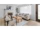 Sun-lit living room featuring modern decor, a cozy fireplace, and stylish light wood floors at 3055 S Winona Ct, Denver, CO 80236