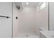 Sleek, all-white shower with a unique tile pattern and modern fixtures at 3055 S Winona Ct, Denver, CO 80236