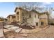 The backyard is landscaped with stone steps, gravel beds, and a covered patio with a grill at 6071 S Detroit St, Centennial, CO 80121