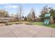 Flat backyard with custom patio, synthetic grass, and play set at 6071 S Detroit St, Centennial, CO 80121