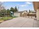 Fenced backyard with a play set, grassy area, and detached garage at 6071 S Detroit St, Centennial, CO 80121