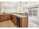 Basement bar boasts stainless fridge, sink, wood cabinets and granite counters at 6071 S Detroit St, Centennial, CO 80121