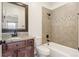 Bathroom features tiled shower, granite countertops, and wooden vanity at 6071 S Detroit St, Centennial, CO 80121