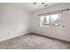 This bedroom has carpet floors and a large window with a view to the outdoors at 6071 S Detroit St, Centennial, CO 80121