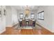An airy dining room boasts hardwood floors, a modern chandelier, and classic window shutters at 6071 S Detroit St, Centennial, CO 80121