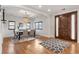 Elegant dining room with hardwood floors, chandelier, and a large wooden door at 6071 S Detroit St, Centennial, CO 80121