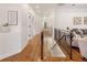 Bright hallway features wood floors, white trim, and a staircase to basement at 6071 S Detroit St, Centennial, CO 80121