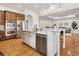 Bright kitchen features stainless appliances, granite countertops, and wood floors at 6071 S Detroit St, Centennial, CO 80121