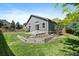 Well-maintained backyard featuring a lush lawn, garden beds, and a patio area perfect for outdoor entertaining at 5932 S Versailles St, Aurora, CO 80015