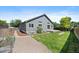 Expansive backyard with a well-kept lawn, garden, patio, and tasteful landscaping, perfect for outdoor enjoyment at 5932 S Versailles St, Aurora, CO 80015
