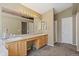 Well-lit bathroom featuring dual sinks, large mirrors, vanity cabinets, and a separate shower at 5932 S Versailles St, Aurora, CO 80015