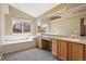 Bright bathroom with a soaking tub, dual sinks, and ample counter space perfect for relaxation and functionality at 5932 S Versailles St, Aurora, CO 80015
