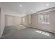 Empty room with neutral walls and carpet provides a blank canvas for creating a personalized living space at 5932 S Versailles St, Aurora, CO 80015