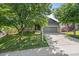 Charming home with a two-car garage, mature trees, and a well-maintained lawn at 5932 S Versailles St, Aurora, CO 80015