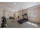 Well-equipped home gym features an elliptical machine, treadmill, weights, and ample space for workouts at 5932 S Versailles St, Aurora, CO 80015