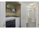 A laundry room with a full sized washer and dryer and a shelf at 5932 S Versailles St, Aurora, CO 80015