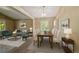 A bright living room and dining area includes modern furniture and natural light at 5932 S Versailles St, Aurora, CO 80015