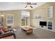 Cozy living room with natural light, a ceiling fan, and built-in shelving at 5932 S Versailles St, Aurora, CO 80015