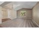 Bright living room features vaulted ceilings, plush carpet, and natural light at 5932 S Versailles St, Aurora, CO 80015