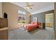 Spacious main bedroom featuring high ceilings, large windows, and an ensuite bathroom at 5932 S Versailles St, Aurora, CO 80015