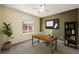 Bright office space with a modern desk, comfortable chair, and a window with a pleasant neighborhood view at 5932 S Versailles St, Aurora, CO 80015