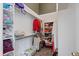 Organized walk-in closet features shelving and hanging racks, offering ample storage space for clothes and accessories at 5932 S Versailles St, Aurora, CO 80015