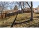 Sloping backyard features a wooden fence and mature trees at 9825 W Walker Pl, Littleton, CO 80123