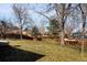 Spacious backyard featuring a large lawn and wooden fence, perfect for outdoor activities and privacy at 9825 W Walker Pl, Littleton, CO 80123