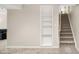 Finished basement showcasing stairs and an alcove with shelving, adding functionality to the space at 9825 W Walker Pl, Littleton, CO 80123