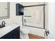 Nicely updated bathroom with a marble tiled tub, stylish vanity and fixtures at 9825 W Walker Pl, Littleton, CO 80123