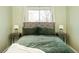 Inviting bedroom with large window, and stylish green bedding at 9825 W Walker Pl, Littleton, CO 80123