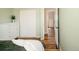 Cozy bedroom with light green walls and a closet with sliding doors at 9825 W Walker Pl, Littleton, CO 80123