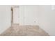 Bright bedroom features neutral carpet, white walls, and access to an adjoining room at 9825 W Walker Pl, Littleton, CO 80123