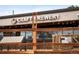 Craft brewery exterior featuring wooden fence, seating, and string lights at 9825 W Walker Pl, Littleton, CO 80123