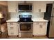 Updated kitchen with white cabinets, stainless steel appliances, and sleek countertops at 9825 W Walker Pl, Littleton, CO 80123