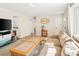Bright, spacious living room with wood floors and a view into the kitchen at 9825 W Walker Pl, Littleton, CO 80123