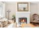 Living room with fireplace, wood floors, and a large mirror above the mantle at 9825 W Walker Pl, Littleton, CO 80123