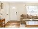 Bright living room featuring wood floors, neutral walls, and abundant natural light at 9825 W Walker Pl, Littleton, CO 80123