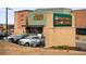 Exterior shot of Natural Grocers store with parking lot, brick and wood facade at 9825 W Walker Pl, Littleton, CO 80123