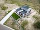 Aerial view of a modern home with meticulous landscaping and long driveway, sitting on a large lot at 8765 Canyon Wind St, Parker, CO 80138