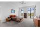 Bright bedroom boasts large windows offering serene views, and stylish modern furnishings at 8765 Canyon Wind St, Parker, CO 80138