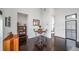 Bright dining area with dark wood floors, white walls, and a modern table set at 8765 Canyon Wind St, Parker, CO 80138